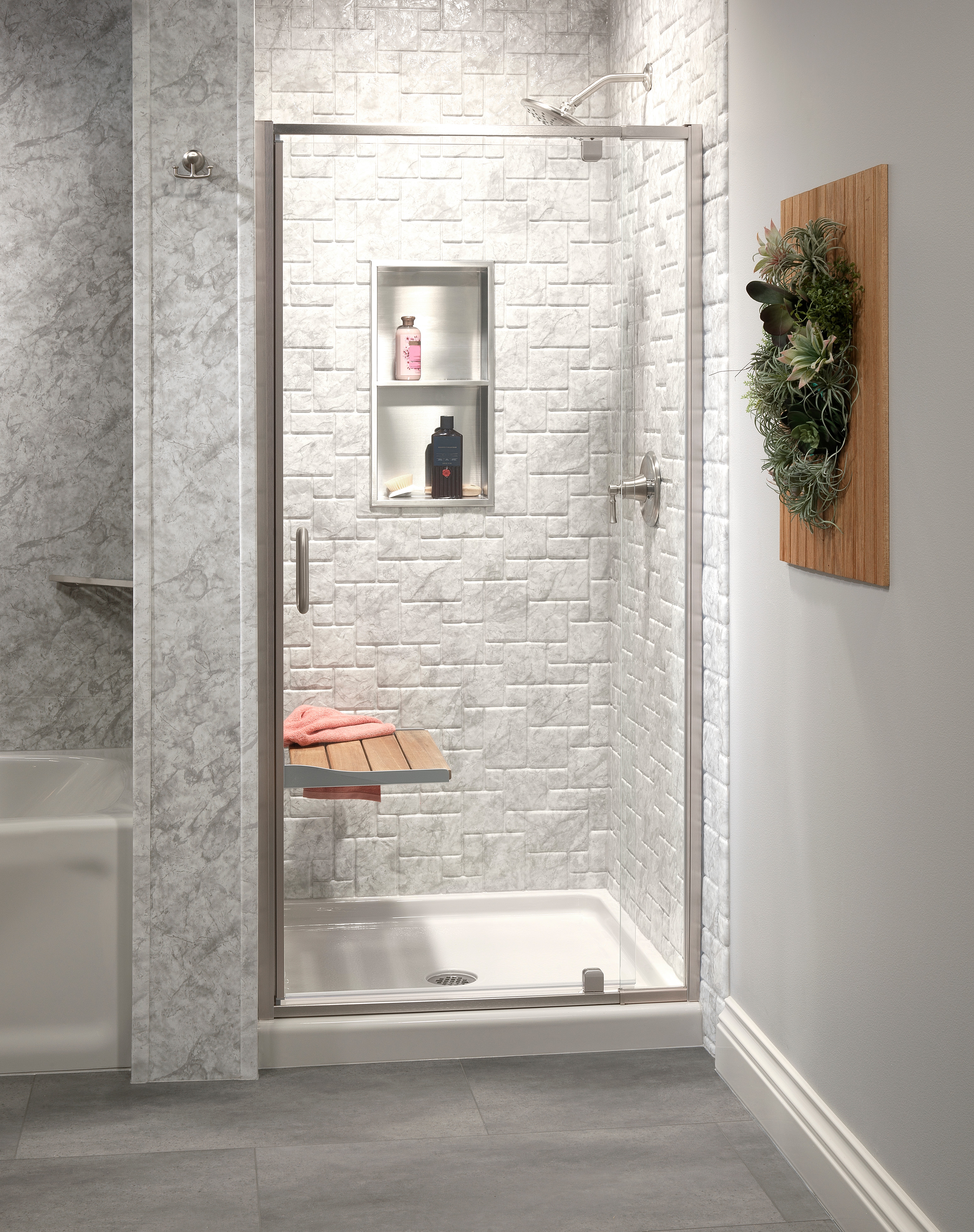 Custom gray brick-tile shower with built-in niche and bench — North Texas project