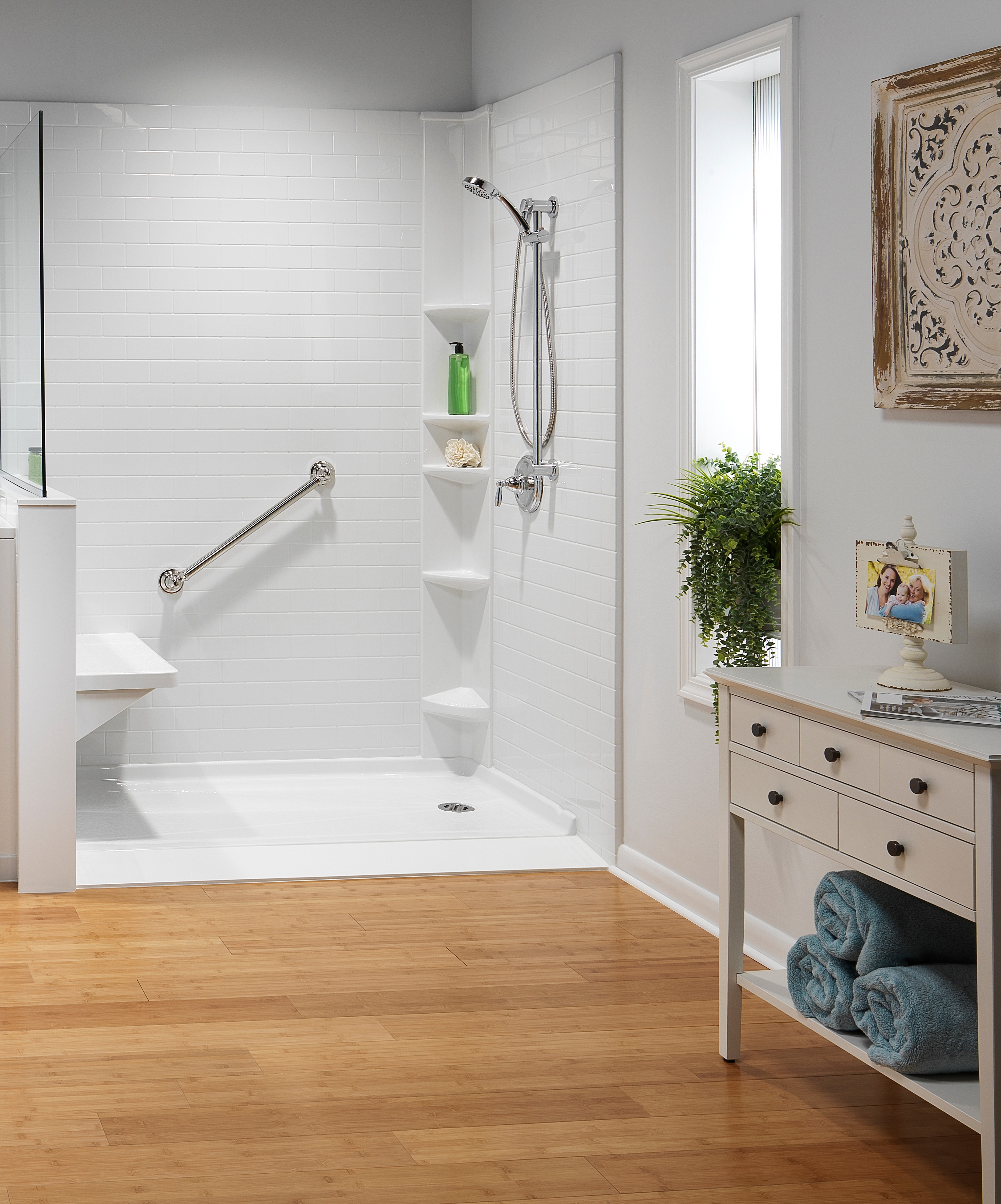 White subway tile shower with bench and grab bar — accessibility remodel