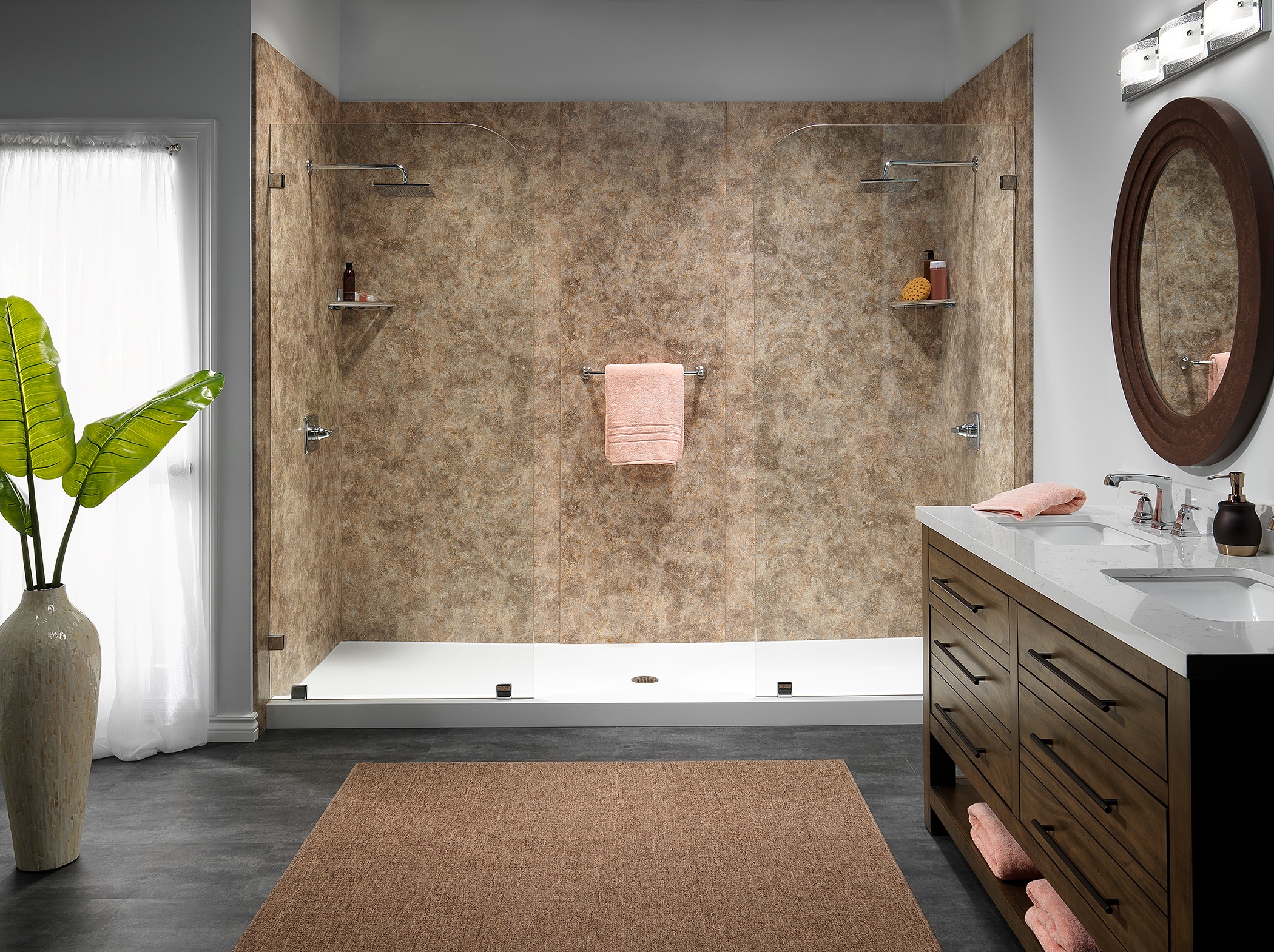 Long wooden vanity with brown textured shower walls — custom bathroom